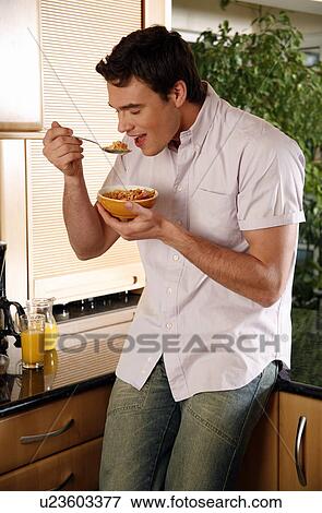 Man eating his breakfast View Large Photo Image Stock Photo - Man eating his breakfast. Fotosearch
