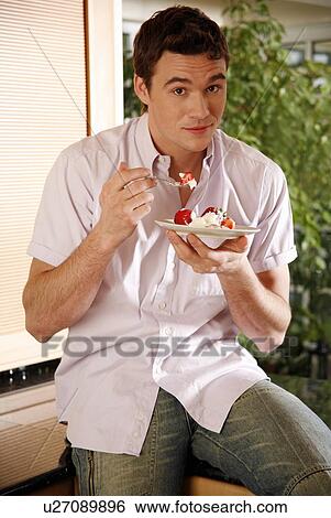 Stock Photograph - Man eating his breakfast. Fotosearch
