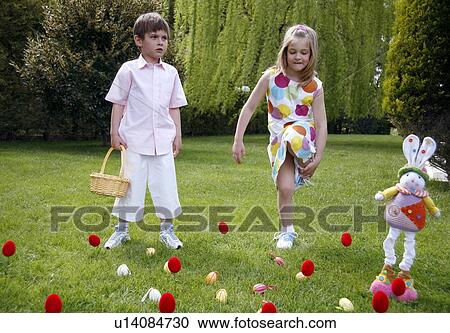 Stock Image - Boy and girl playing in the yard. Fotosearch