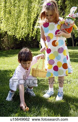 Stock Image - Boy and girl playing in the yard. Fotosearch