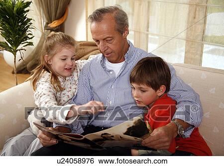 Stock Photograph - Grandfather relaxing with grandchildren. Fotosearch