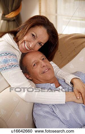 Stock Image - Mature couple relaxing at home. Fotosearch