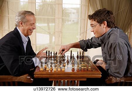 Mature man and younger man playing chess View Large Photo Image Stock Photograph - Mature man and younger man playing chess. Fotosearch