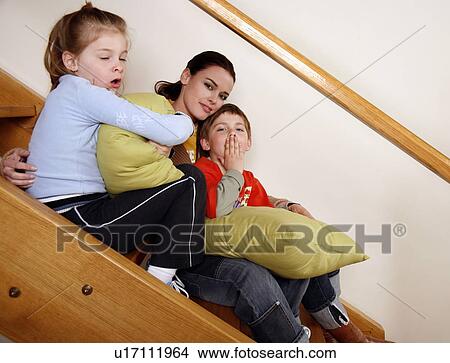 Picture - Mother with tired children on staircase. Fotosearch