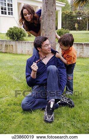Stock Photo - Parents and child playing in the yard. Fotosearch