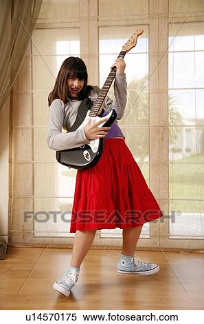 Teenage girl playing the guitar View Large Photo Image Stock Photography - Teenage girl playing the guitar. Fotosearch
