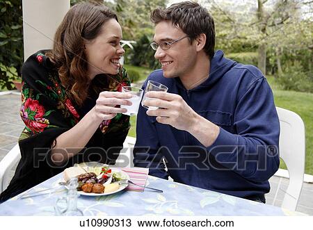 Young couple drinking ouzo View Large Photo Image Stock Image - Young couple drinking ouzo. Fotosearch