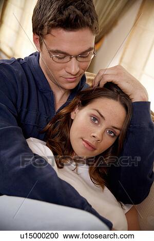 Stock Image - Young couple relaxing at home. Fotosearch