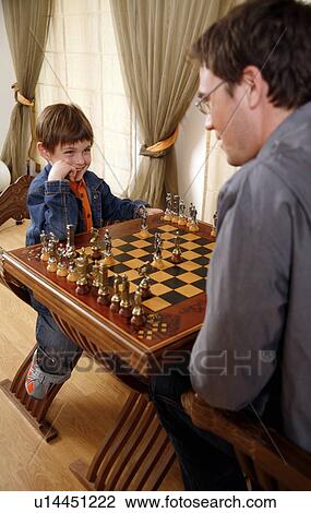 Young man and little boy playing chess View Large Photo Image Stock Image - Young man and little boy playing chess. Fotosearch