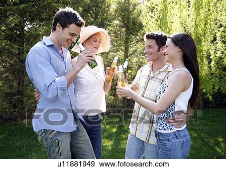 Stock Photo - Group of friends drinking beer. Fotosearch
