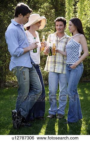 Stock Photograph - Group of friends drinking beer. Fotosearch