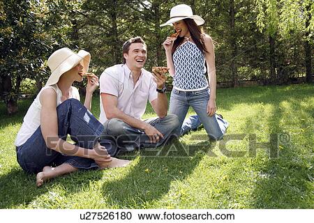 Three friends eating pizza View Large Photo Image Stock Image - Three friends eating pizza. Fotosearch