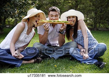 Three friends sharing a big sandwich View Large Photo Image Stock Image - Three friends sharing a big sandwich. Fotosearch