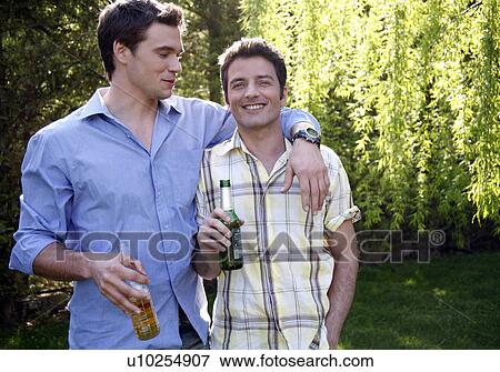 Two men drinking beer View Large Photo Image Stock Photo - Two men drinking beer. Fotosearch