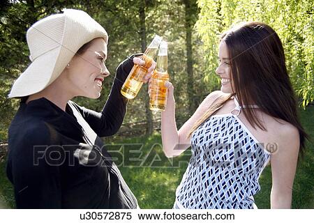 Stock Photography - Two women drinking beer. Fotosearch