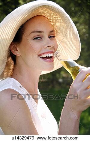 Stock Photo - Woman drinking a beer. Fotosearch