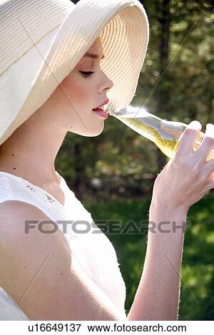 Stock Photo - Woman drinking a beer. Fotosearch