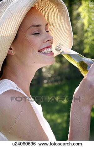 Stock Photograph - Woman drinking a beer. Fotosearch