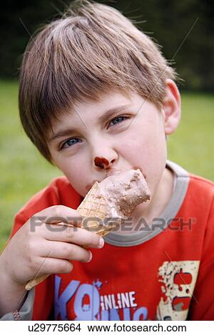 Picture - Young boy eating ice cream . Fotosearch