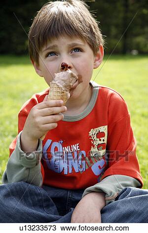 Young boy eating ice cream View Large Photo Image Stock Image - Young boy eating ice cream . Fotosearch