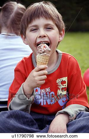Young boy eating ice cream  View Large Photo Image Stock Photo - Young boy eating ice cream . Fotosearch