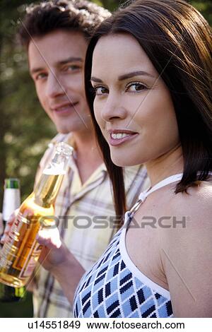 Stock Photo - Young couple drinking beer. Fotosearch