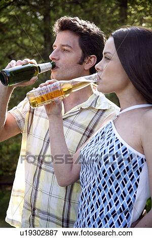 Young couple drinking beer View Large Photo Image Stock Photo - Young couple drinking beer. Fotosearch