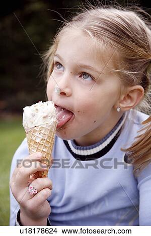 Young girl eating ice cream View Large Photo Image Picture - Young girl eating ice cream . Fotosearch