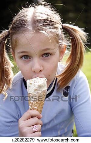 Stock Photo - Young girl eating ice cream . Fotosearch