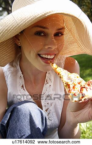 Young woman eating pizza View Large Photo Image Stock Image - Young woman eating pizza. Fotosearch
