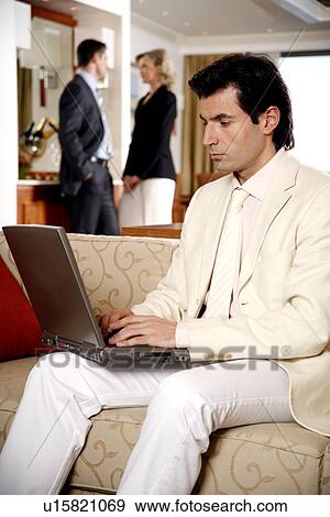 Bussinessman working on a laptop computer View Large Photo Image Stock Photo - Bussinessman working on a laptop computer. Fotosearch