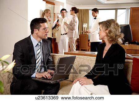 Stock Photo - Bussinessman working on a laptop computer during meeting. Fotosearch