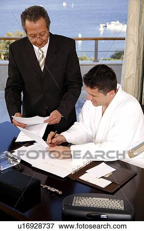 Two businessmen working in a hotel room View Large Photo Image Stock Photo - Two businessmen working in a hotel room. Fotosearch