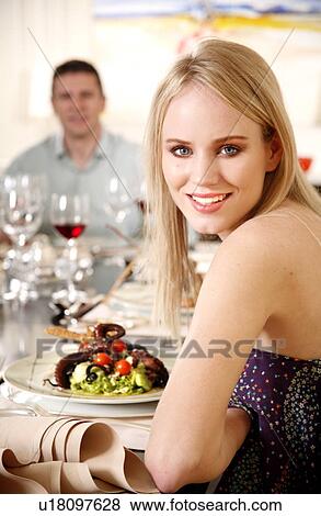 Stock Photo - Young woman dining in a restaurant. Fotosearch