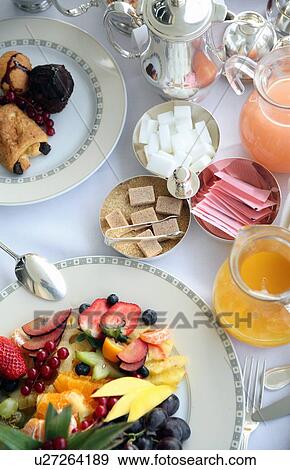 Breakfast table with fruit, pastries, juices View Large Photo Image Stock Photo - Breakfast table with fruit, pastries, juices. Fotosearch