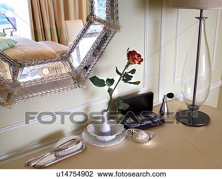 Stock Image - Dresser with rose in a vase. Fotosearch