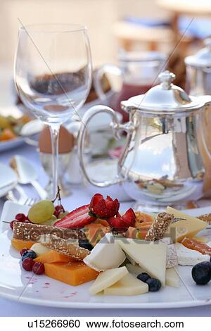 Stock Image - Stylized assortment of fruits and cheeses. Fotosearch