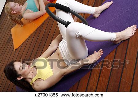 Stock Photography - Two young women performing a pilates exercise. Fotosearch