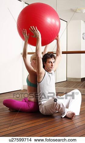 Young man and woman performing a pilates exercise View Large Photo Image Picture - Young man and woman performing a pilates exercise. Fotosearch