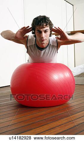 Young man performing a pilates exercise View Large Photo Image Stock Photo - Young man performing a pilates exercise. Fotosearch