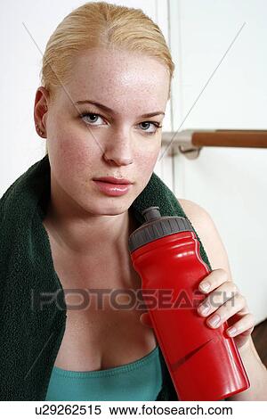Young woman in exercise gear with a water bottle View Large Photo Image Stock Photography - Young woman in exercise gear with a water bottle. Fotosearch