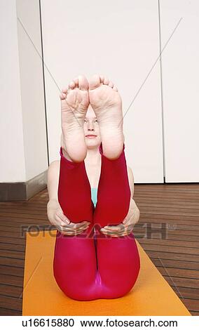 Young woman performing a pilates exercise View Large Photo Image Stock Image - Young woman performing a pilates exercise. Fotosearch