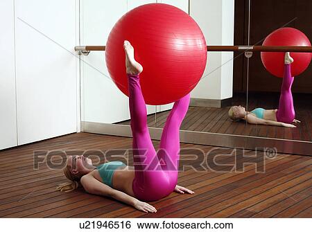 Stock Photograph - Young woman performing a pilates exercise. Fotosearch
