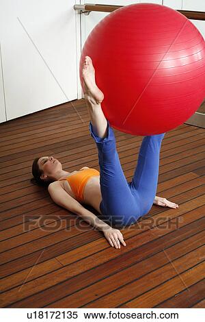 Stock Photography - Young woman performing a pilates exercise. Fotosearch