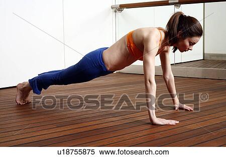 Young woman performing a pilates exercise View Large Photo Image Stock Photography - Young woman performing a pilates exercise. Fotosearch