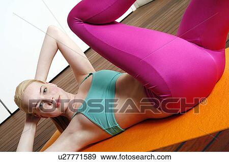 Young woman performing a pilates stretch View Large Photo Image Stock Photo - Young woman performing a pilates stretch. Fotosearch