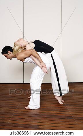 Partners practicing flexibility in yoga and Capoeira programs View Large Photo Image Stock Image - Partners practicing flexibility in yoga and Capoeira programs. Fotosearch