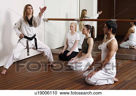 Stock Image - Students observing Tae Kwon Do - Dantae demonstration. Fotosearch