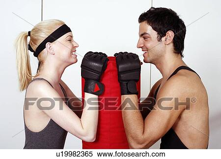 Young man and woman flirting in a fitness class View Large Photo Image Stock Photography - Young man and woman flirting in a fitness class. Fotosearch