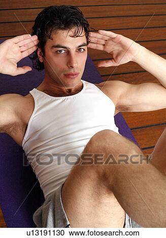 Young man doing situps View Large Photo Image Stock Image - Young man doing situps. Fotosearch